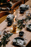 H̦fats Spin tafelvuur - PartyfurnitureHofats spin tafelvuur rvs met glas, kleur goud op een kersttafel